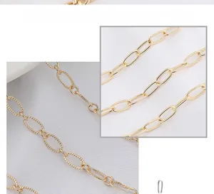 Macro view of gold copper flat O-chain with smooth and embossed textured jewelry links