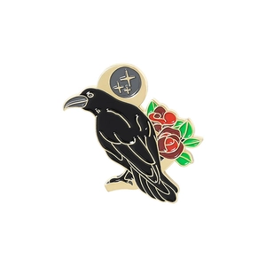 Detail of gothic raven and red rose enamel brooch pin with a golden crescent moon