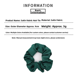 Detail showing high-gloss emerald green satin scrunchie with 9cm diameter dimensions