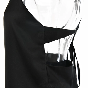 Detailed close-up of black satin top featuring lace-up back design and hollow-out detail