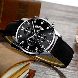 Detail of Roman numeral dial with faux diamond markers and leather strap on vintage book
