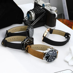 Close-up of luxury business quartz watches with leather straps and calendar display