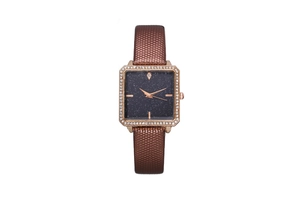 Detail of square rose gold watch with starry blue dial and brown textured leather strap