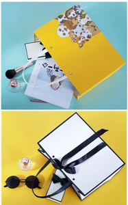 Detail of paper gift bags featuring cartoon pet dogs and an elegant black bow ribbon handle