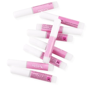 Macro shot of 2g professional nail glue tubes with precision tips and pink labeling