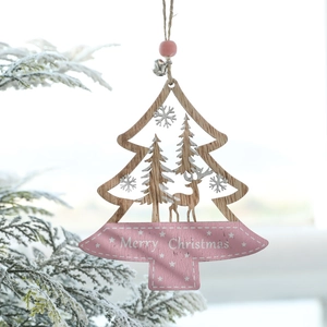 Pink wooden Christmas tree ornament with reindeer cutout and bells on snowy branches