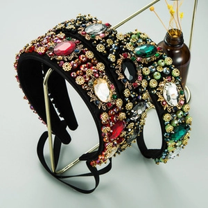 Macro shot of two Baroque velvet headbands with sparkling crystals and gold floral accents