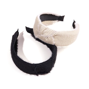 Pair of knurled velvet wide headbands in black and beige with elegant twist detail