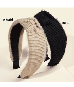 Detail of khaki and black knit headbands featuring top knots and plush trim textures