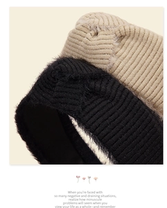 Macro shot of two-tone mohair knit headband texture in black and beige ribbed fabric