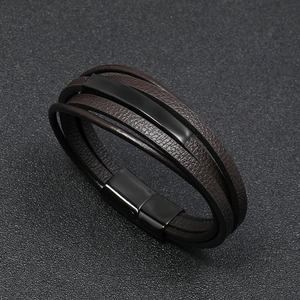 Detail shot of multi-layer brown leather bracelet with black magnetic clasp and metal bars
