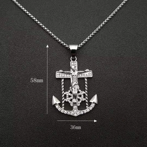 Silver Jesus anchor cross pendant with shiny diamonds on dark textured background