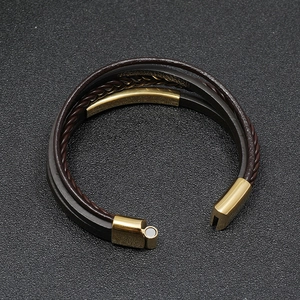 Mens multi-layer braided leather bracelet with gold magnetic clasp on black background