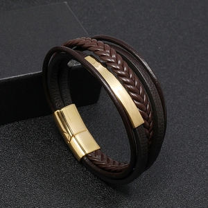 Detail of dark brown multi-layer braided leather bracelet with gold magnetic metal clasp