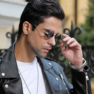 Steampunk round sunglasses styled with a black leather jacket and silver chain necklace