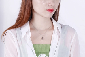 Close-up of minimalist silver stainless steel double gourd pendant necklace on a model