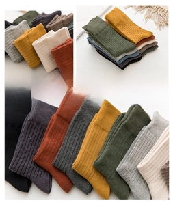 Detailed close-up of premium ribbed cotton socks in various warm autumn colors