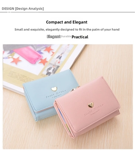 Close-up of light blue and pink tri-fold wallets with gold heart hardware on wood surface