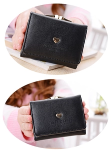 Detail of a black trifold wallet featuring a golden heart and Sweet Dream engraving