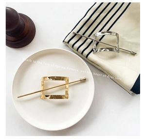 Detail showing gold and silver geometric square hair pins on white and fabric backdrops