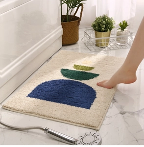 Close-up of plush tufted bathroom mat with colorful semi-circle geometric patterns
