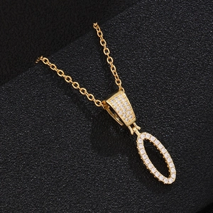 Close-up of golden oval pendant necklace with shimmering micro-pave cubic zirconia stones