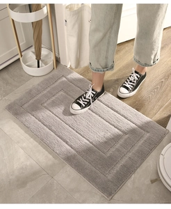 Detailansicht der dicken grauen Badematte mit weicher Textur und rutschfester Unterseite