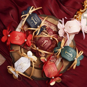 Vintage candy-shaped wedding gift boxes in assorted colors with ribbons and pearls