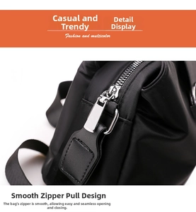 Detail of smooth silver metal zipper with leather puller on black nylon shoulder bag