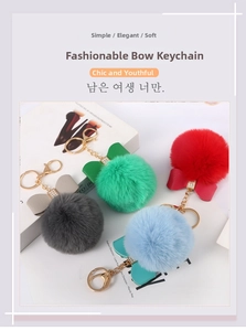 Detailed close-up of colorful faux rabbit fur ball keychains with rhinestone bows