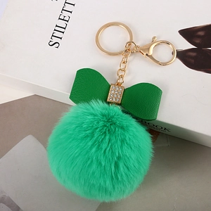 Detail of 8cm lime green faux rabbit fur pom pom keychain with rhinestone bow accent