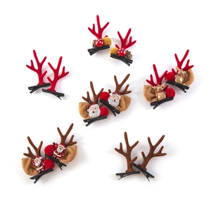 Set of six pairs of Christmas reindeer antler hair clips with festive plush and resin charms