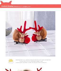 Detail of Christmas reindeer antler hair clips with plush brown deer and red pom-poms