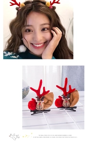 Detail of Christmas reindeer antler hair clips with plush ears and festive red pom-poms