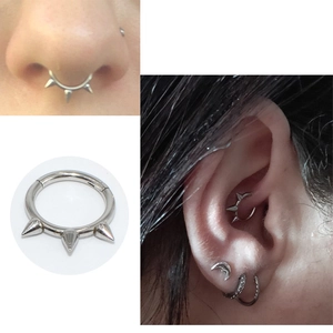 Hinged silver steel septum clicker ring with spikes shown in close-up and on model