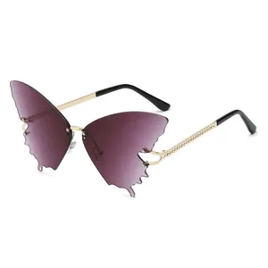 Frameless butterfly-shaped sunglasses with purple gradient lenses and gold metal temples