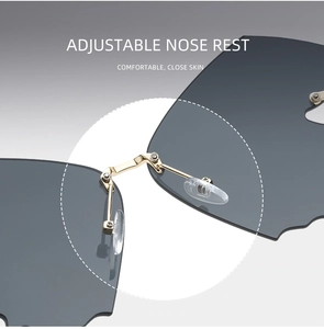 Detail view of adjustable silicone nose pads and golden metal bridge on rimless sunglasses