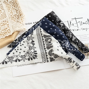 Elastic paisley print headbands in white, navy, and black on minimalist background