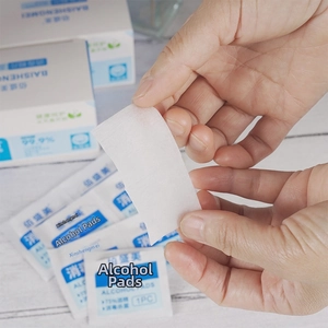 75% alcohol prep pads for sterilization in individual foil packaging held by hand