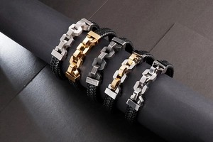 Detail showing various leather braided bracelets with steel chain links in different finishes
