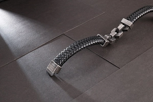 Detail of black braided leather men's bracelet with vintage silver magnetic clasp