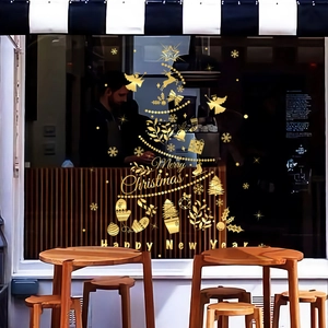 Golden Christmas tree window sticker with festive motifs on a cafe glass storefront