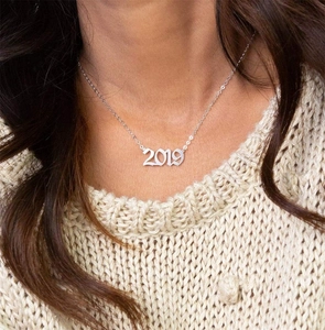 Close-up of a silver stainless steel necklace with 2019 birth year number pendant