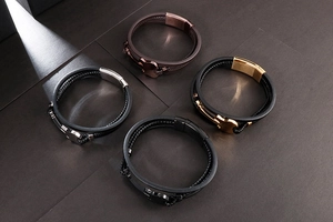 Close-up of multilayer leather and rubber woven bracelets with assorted metal clasps