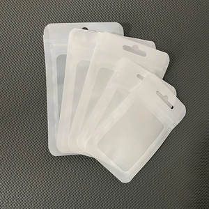 Detail view of five matte white resealable bags with hanging holes and clear front windows