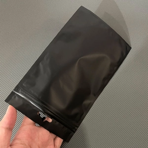 Close-up of matte black aluminum foil zip lock bag with hang hole and easy-tear notch