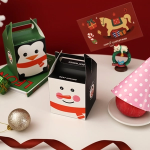 Cartoon Christmas paper gift boxes with cute penguin and snowman designs for holiday candy