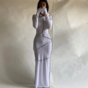 Detail view of white bodycon maxi dress with grey contrast seam stitching and gloves