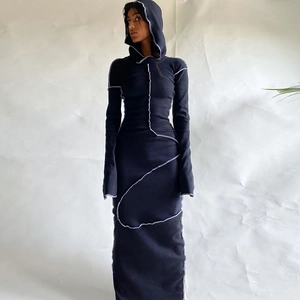 Detail view of the contrasting white stitching on a slim black hooded long-sleeve dress