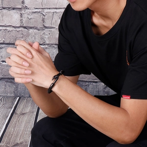 Men's black woven leather bracelet with matte black stainless steel hook clasp on wrist